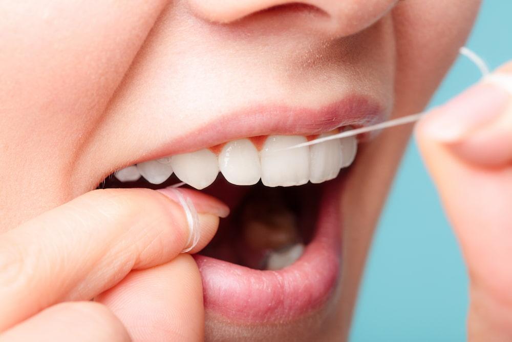 การทำความสะอาดฟันปลอมแบบติดแน่นต้องใช้ไหมขัดฟัน