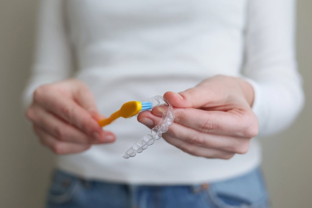 Clean your Invisalign aligners daily