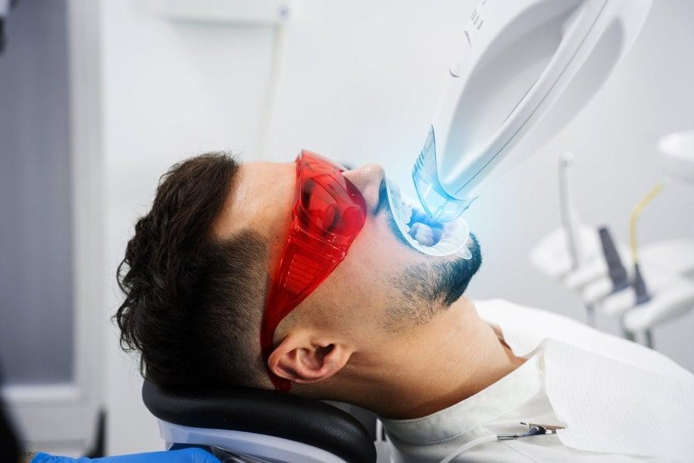 A man undergoes teeth whitening cosmetic dentistry