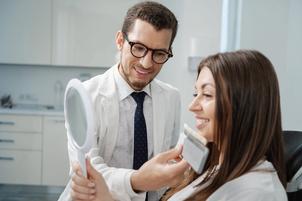 A dentist shows a patient what her smile would look like with veneers.